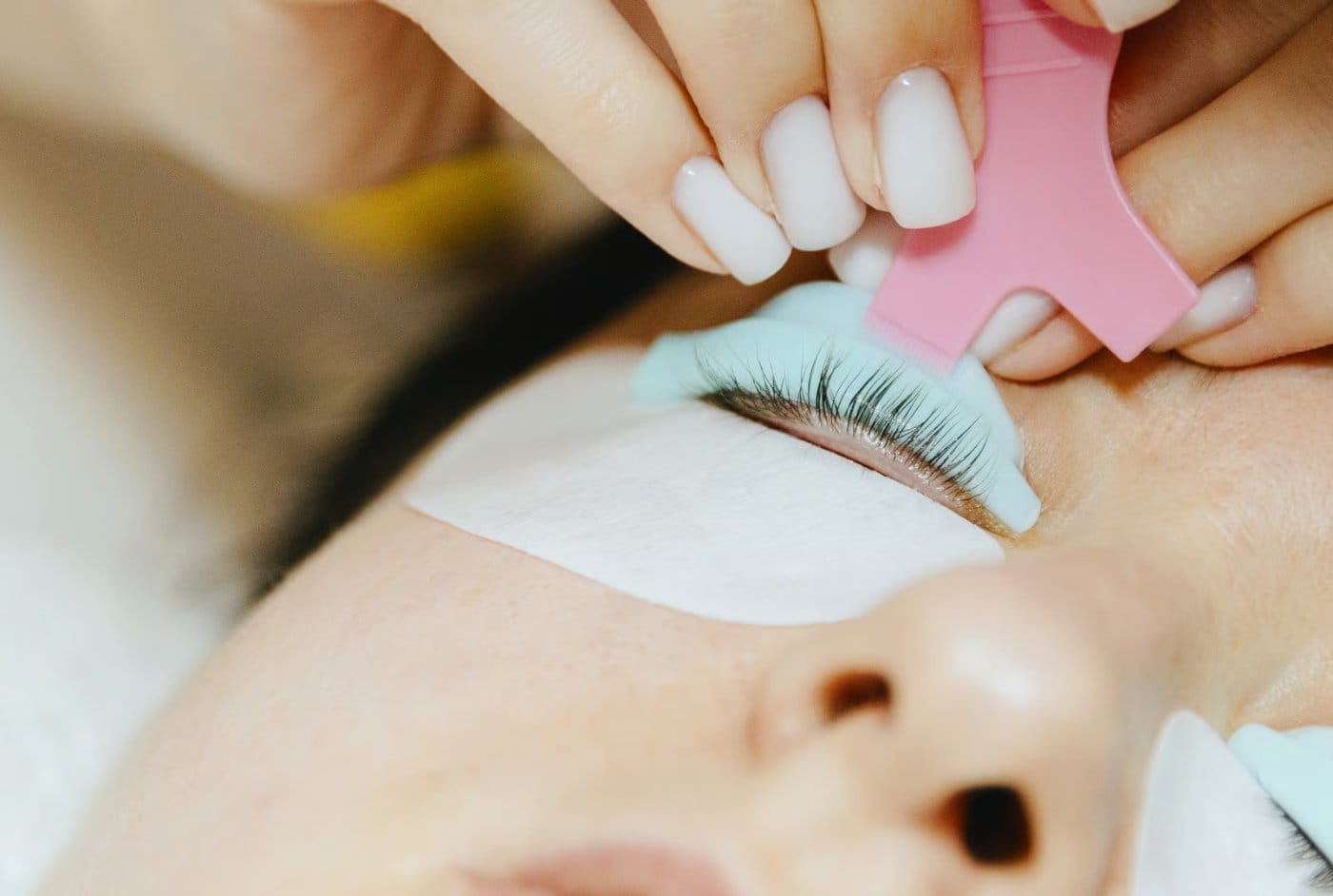 Lash lift in progress, specialist shaping natural lashes during a lash and brow appointment