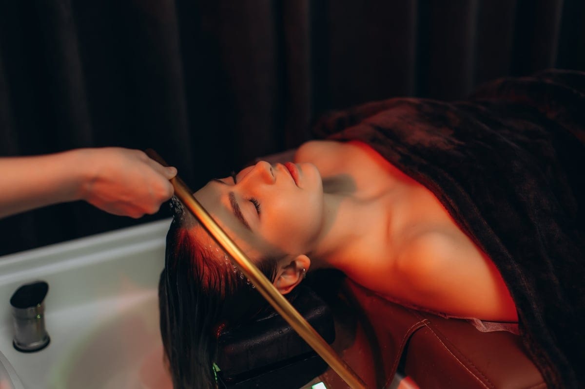 Guest relaxing during a soothing scalp massage at Flamingo House Spa in Nanaimo