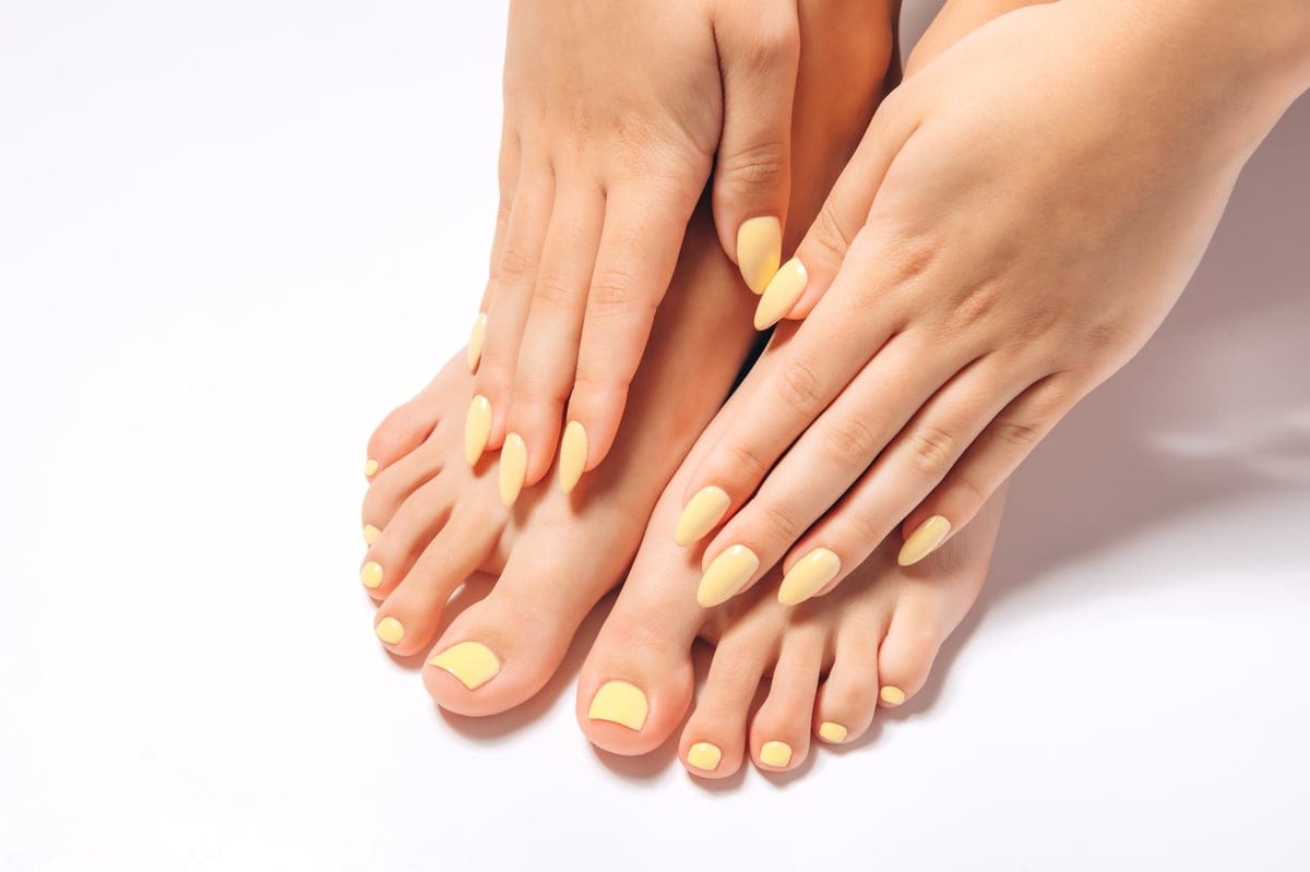 Freshly finished gel manicure and pedicure in matching pastel polish at Flamingo House Spa Nanaimo